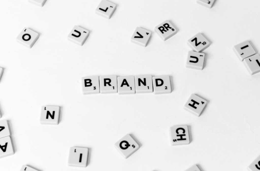 white Scrabble letters spelling the word brand